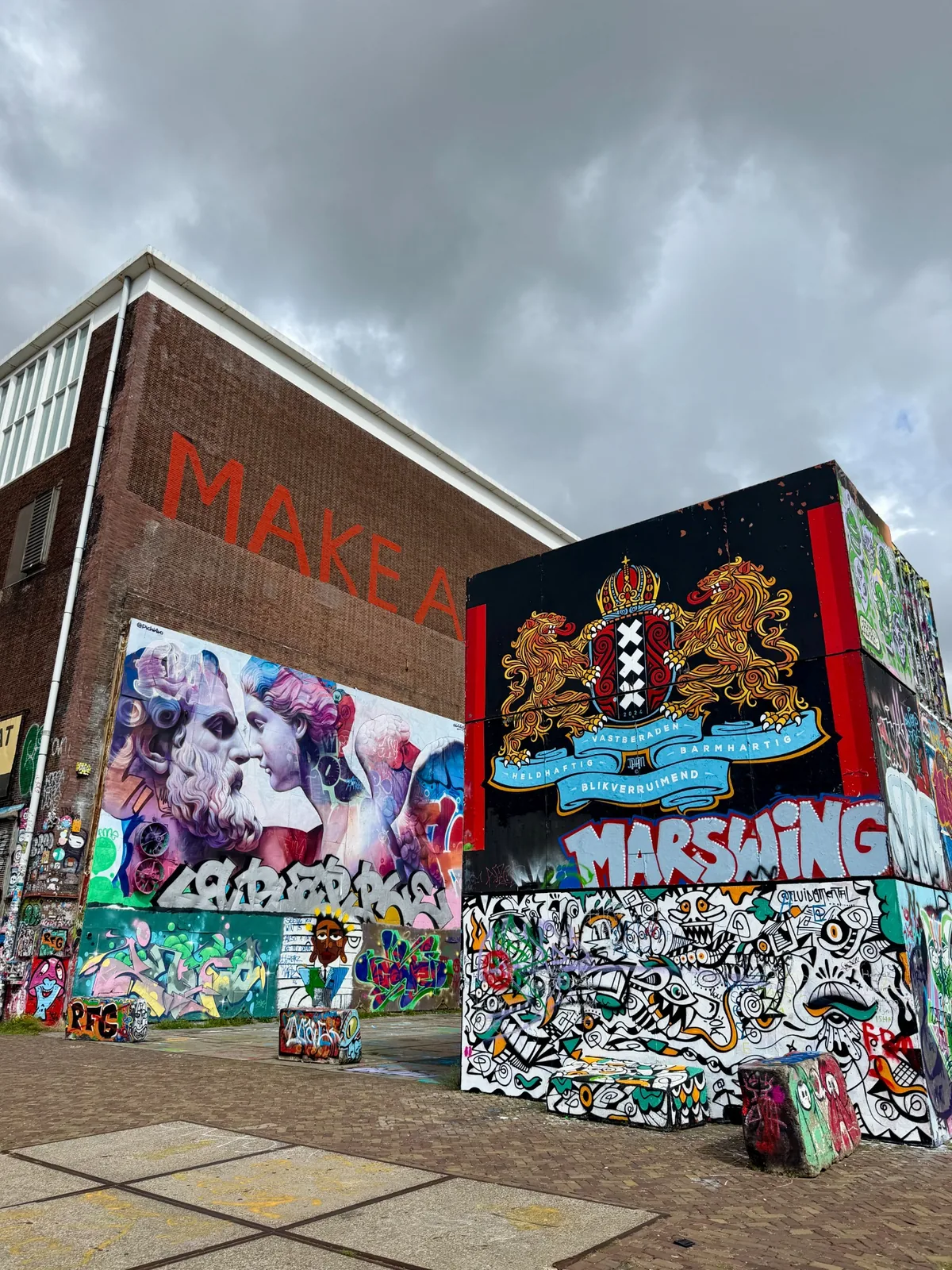 Large street art murals and Amsterdam coat of arms at NDSM